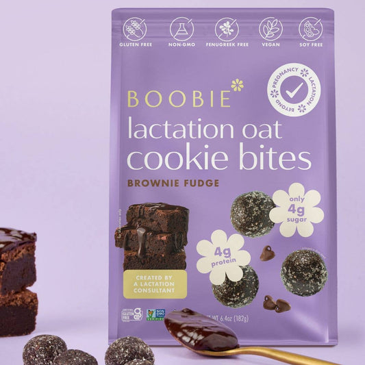 Purple package of Boobie lactation oat cookie bites with brownies and a spoon on a light purple background