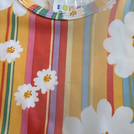 Colorful fabric with floral patterns with a very small stain on it