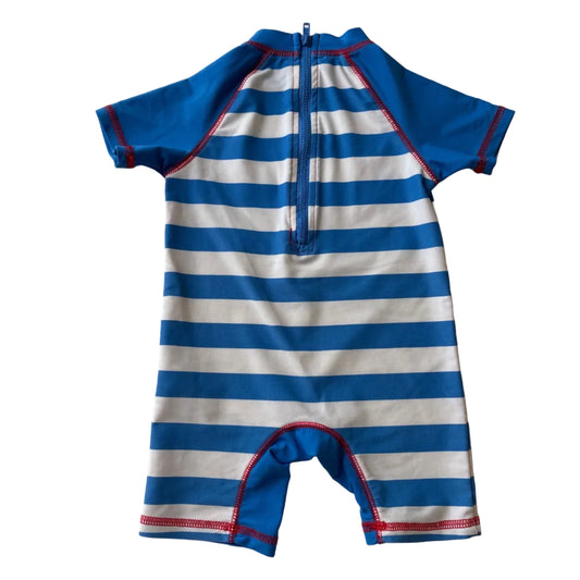 Blue and white striped swimsuit on a white surface
