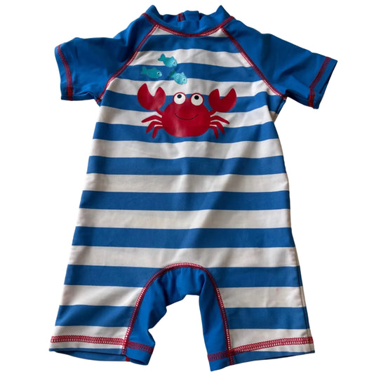 Children's swimsuit with blue and white stripes and a red crab design on a white background
