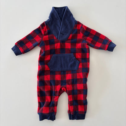 A baby's long-sleeve footless one-piece jumpsuit featuring a red and navy buffalo plaid pattern with solid navy blue trim on the collar, cuffs, and pockets, laid flat on a light gray background.