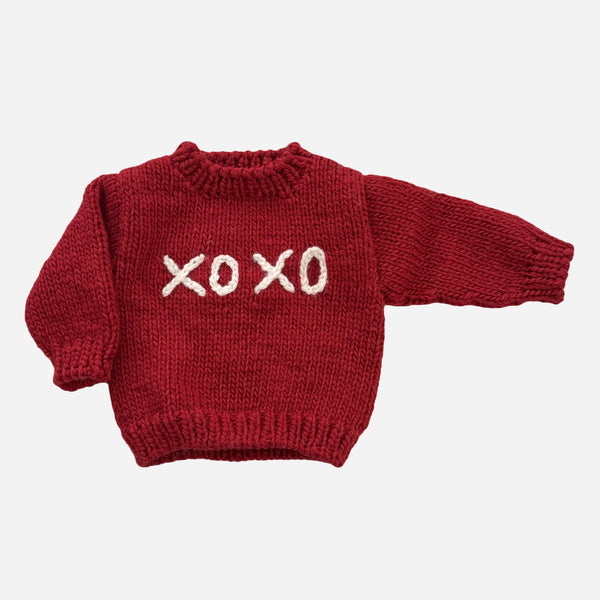 Red knit toddler Valentine’s Day sweater, unisex, that says XOXO in white writing