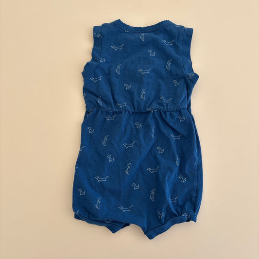 Blue baby romper with patterns on a beige background
