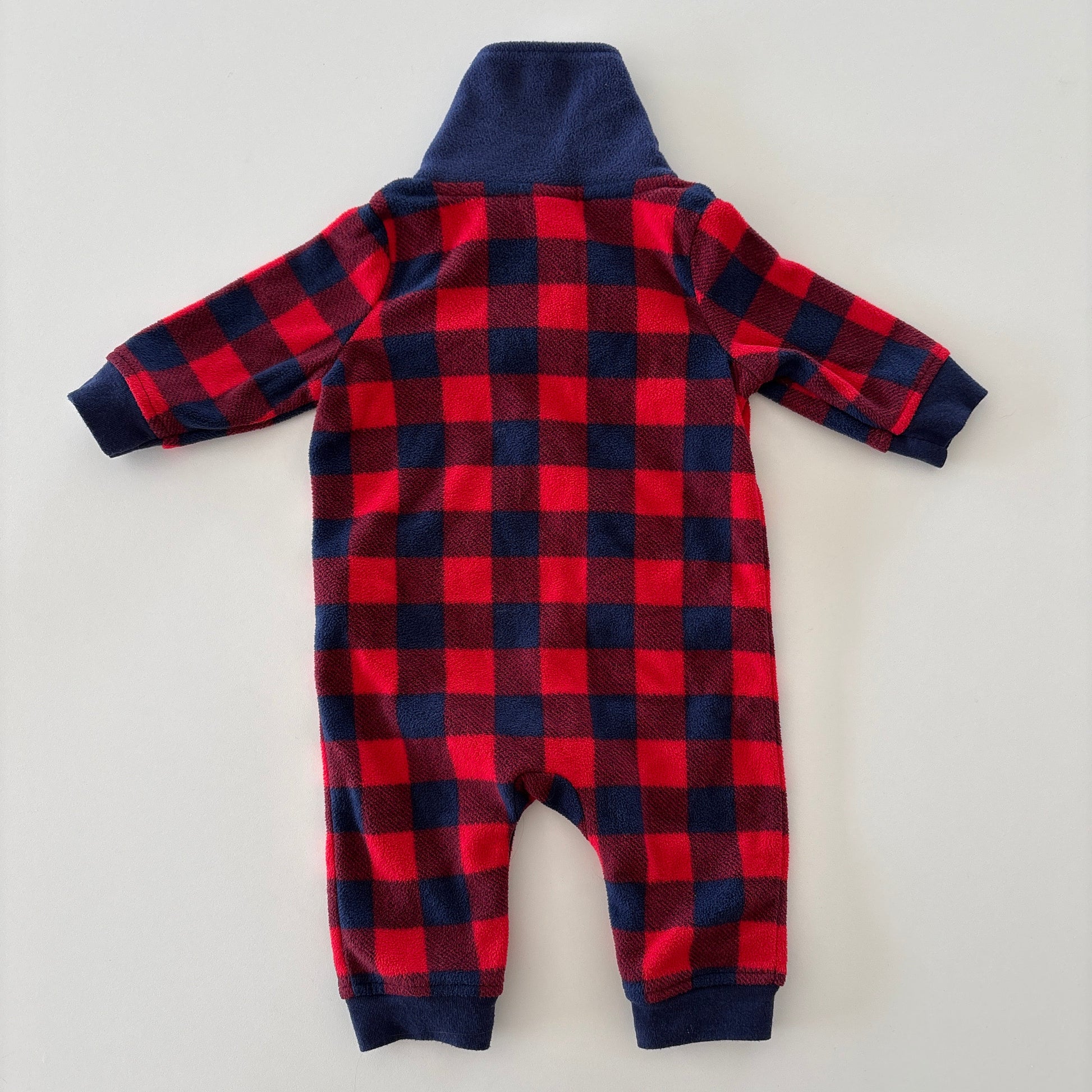 A baby's long-sleeve footless one-piece jumpsuit shown from the back, featuring a red and navy buffalo plaid pattern with a solid navy blue collar and cuffs.
