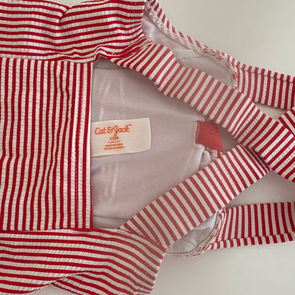 Red and white striped garment with a visible brand label on a light background