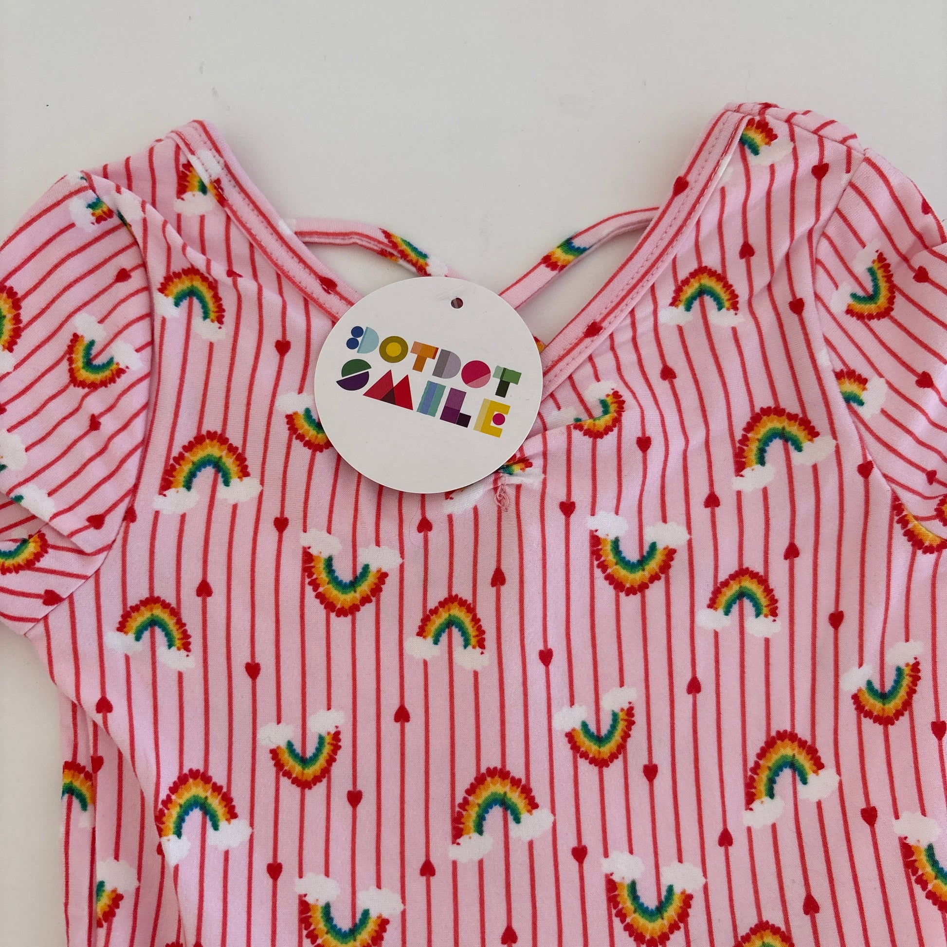 Red and white striped fabric with rainbow patterns and a visible brand tag.