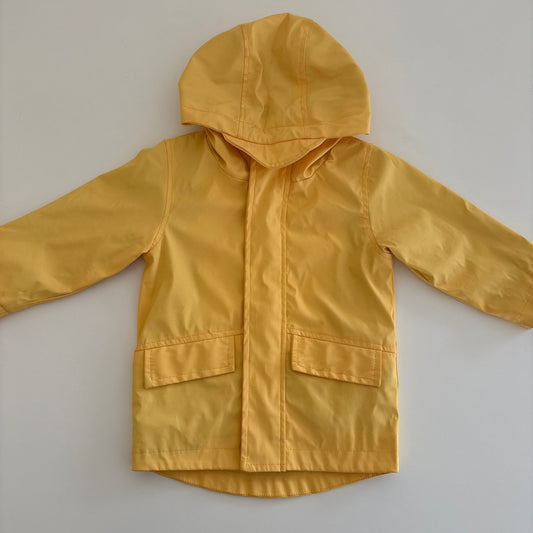 Yellow raincoat on a white surface