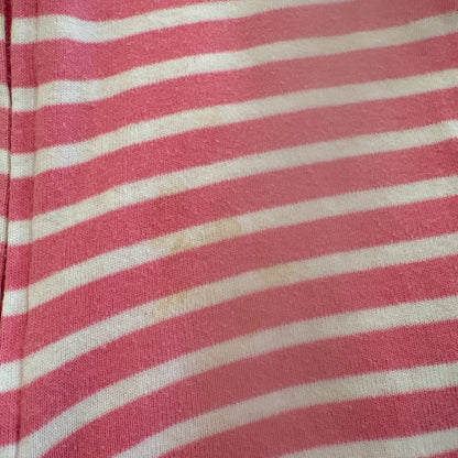 Close-up of pink and white striped fabric to show small stain