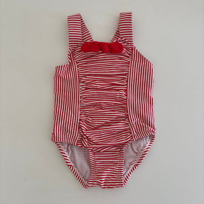 Red and white striped baby outfit on a light gray background