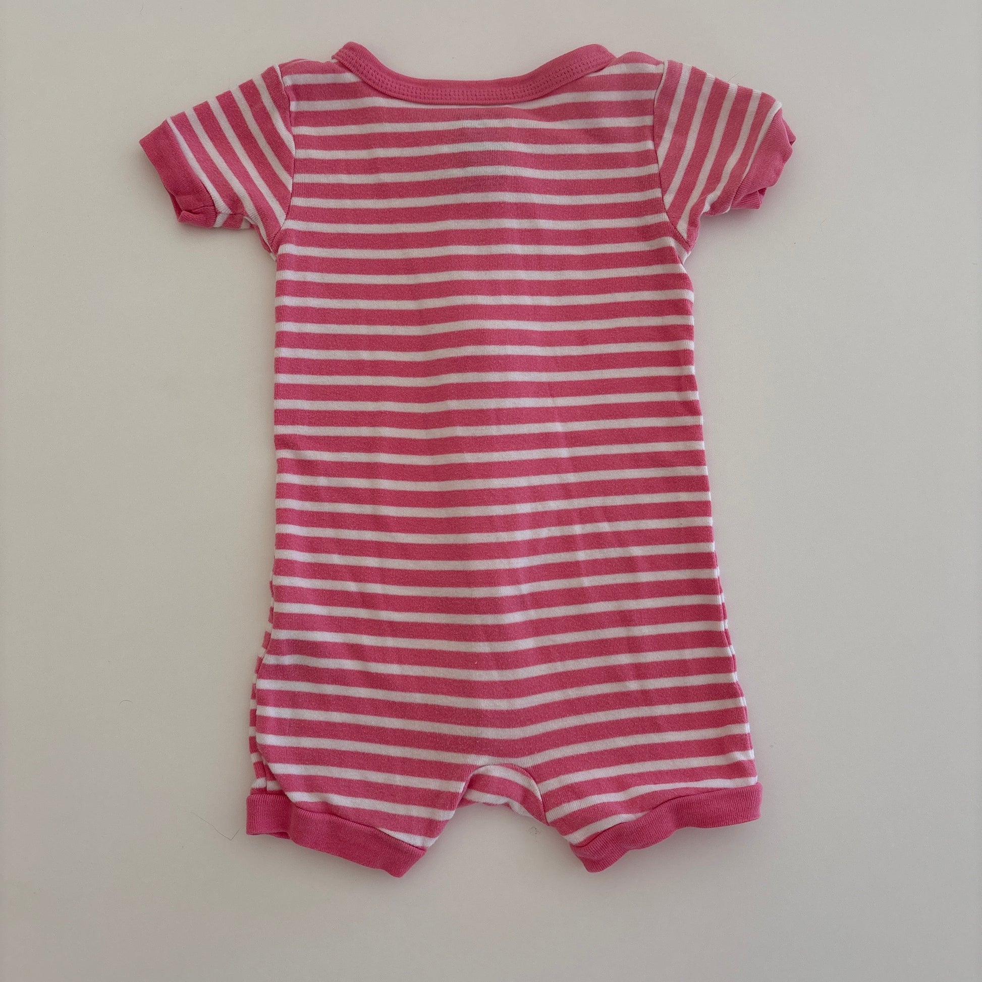 Pink and white striped baby romper on a light gray background