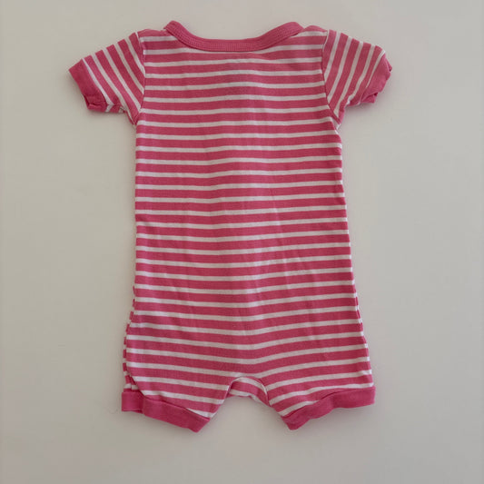 Pink and white striped baby romper on a light gray background