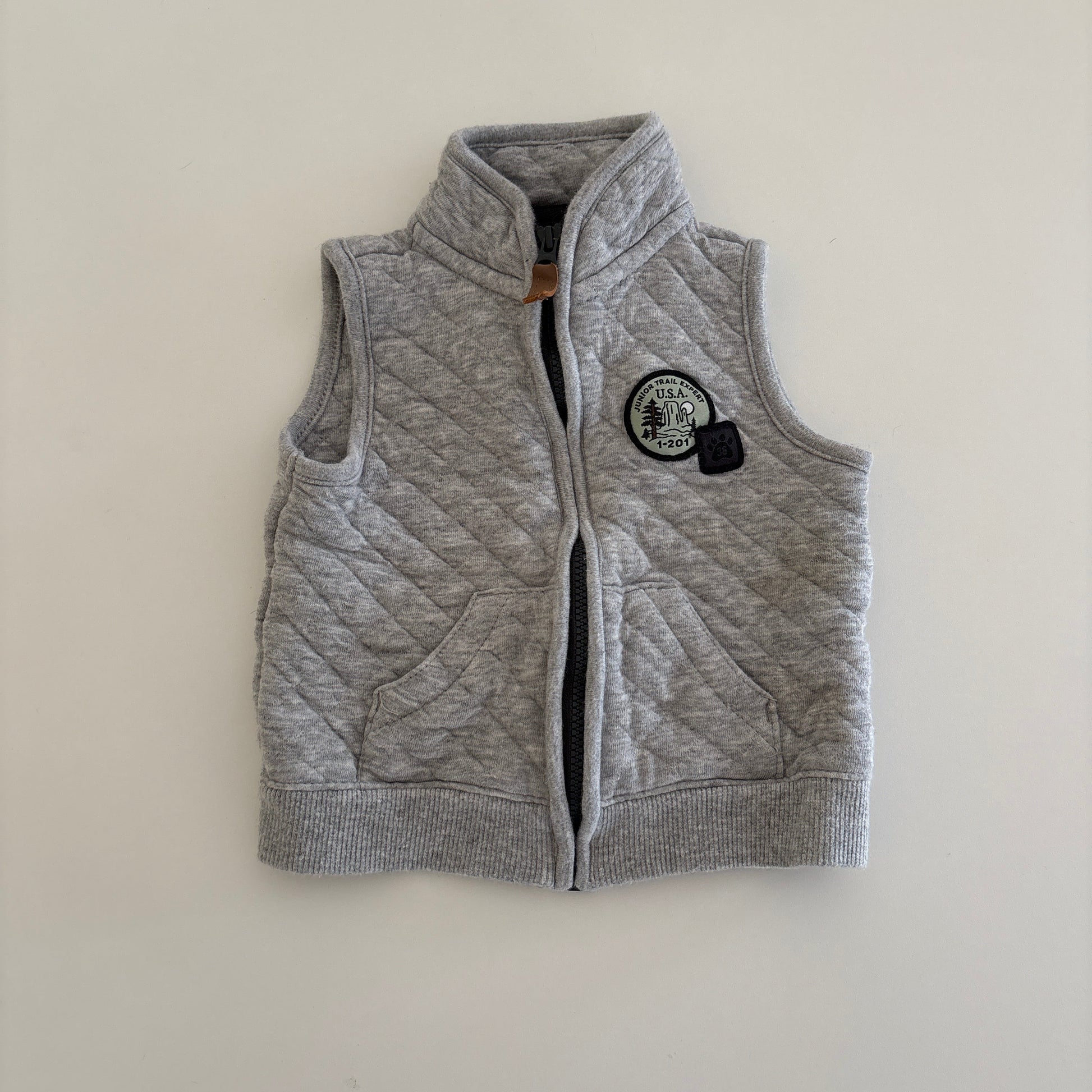 Gray zip up vest on light background