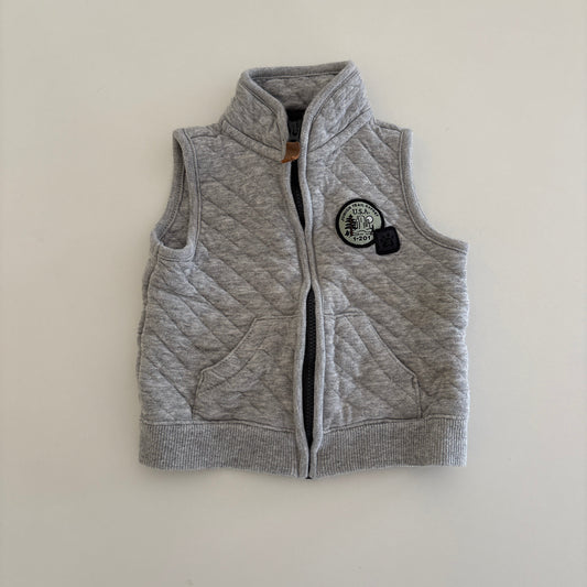 Gray zip up vest on light background