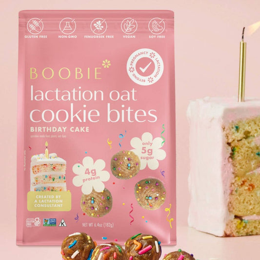 Package of Boobie Lactation Oat Cookie Bites Birthday Cake flavor on a pink background
