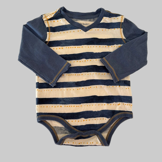 Striped outfit with navy and beige colors on a beige background
