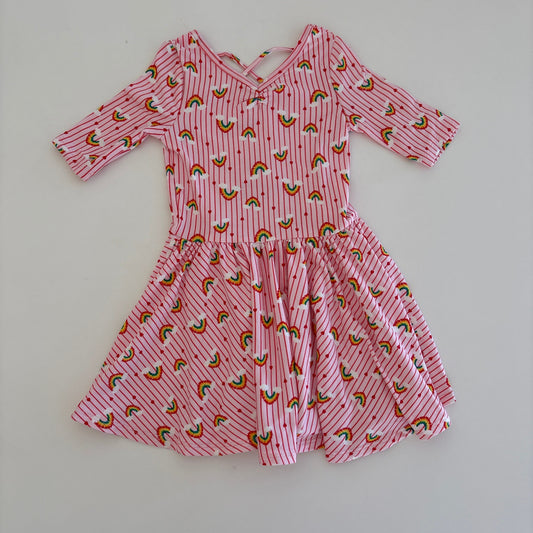 Pink rainbow patterned dress on a white surface