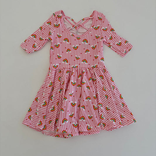 Pink dress with rainbow pattern on a white surface