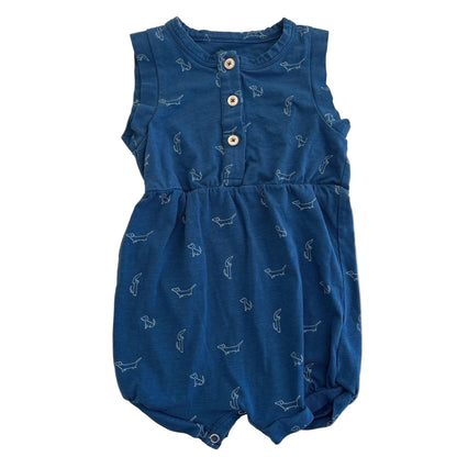 Blue baby romper with white patterns on a beige background