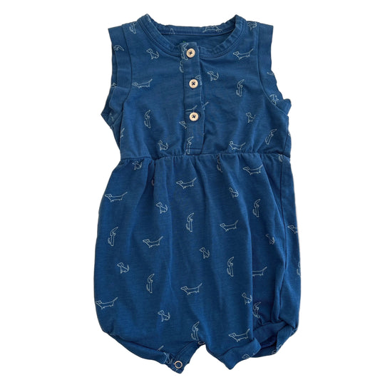 Blue baby romper with white patterns on a beige background
