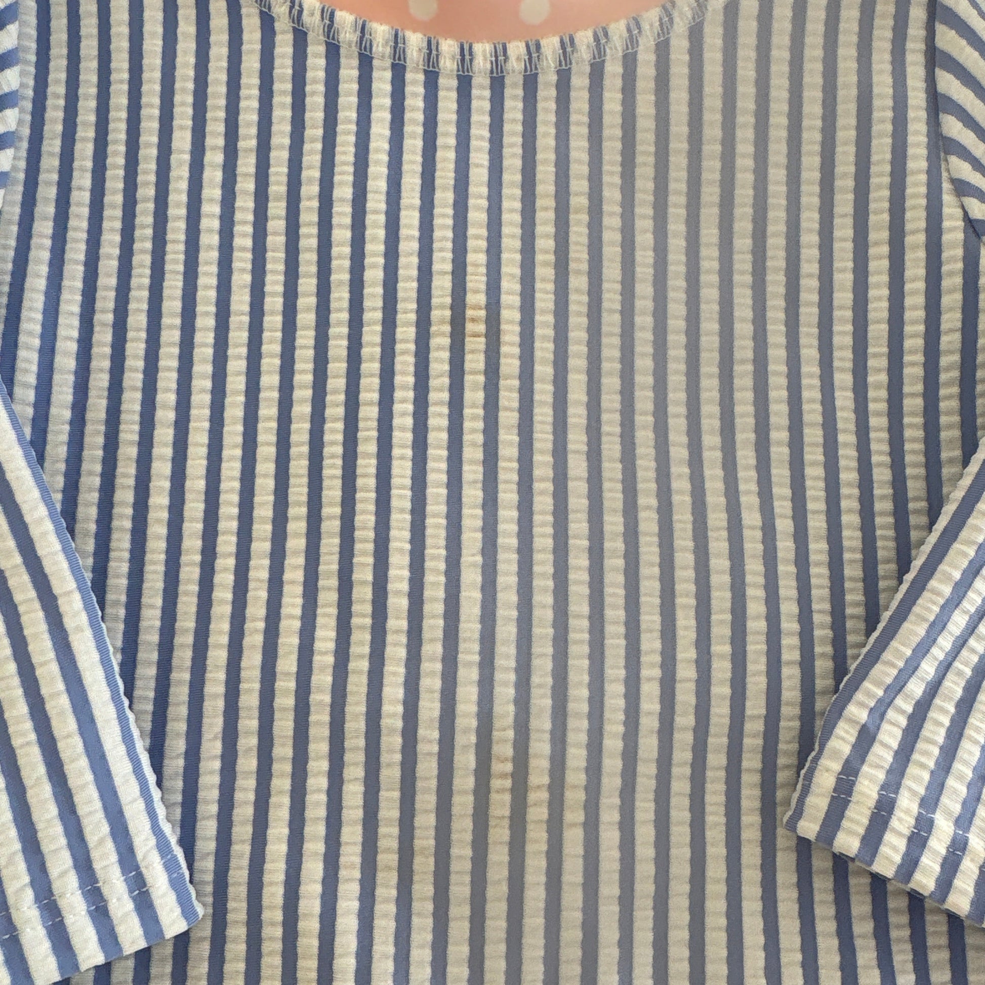 Shows small discolorations on front of swimsuit