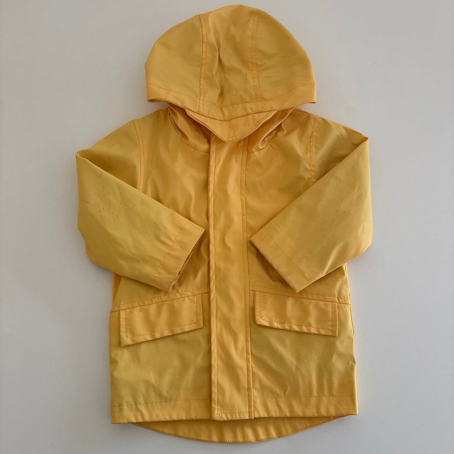 Yellow raincoat on a white background