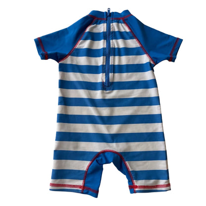 Blue and white striped swimsuit on a white surface