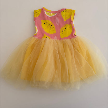 Yellow tutu with pink and yellow patterned waistband on a white background