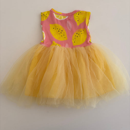 Yellow tutu with pink and yellow patterned waistband on a white background