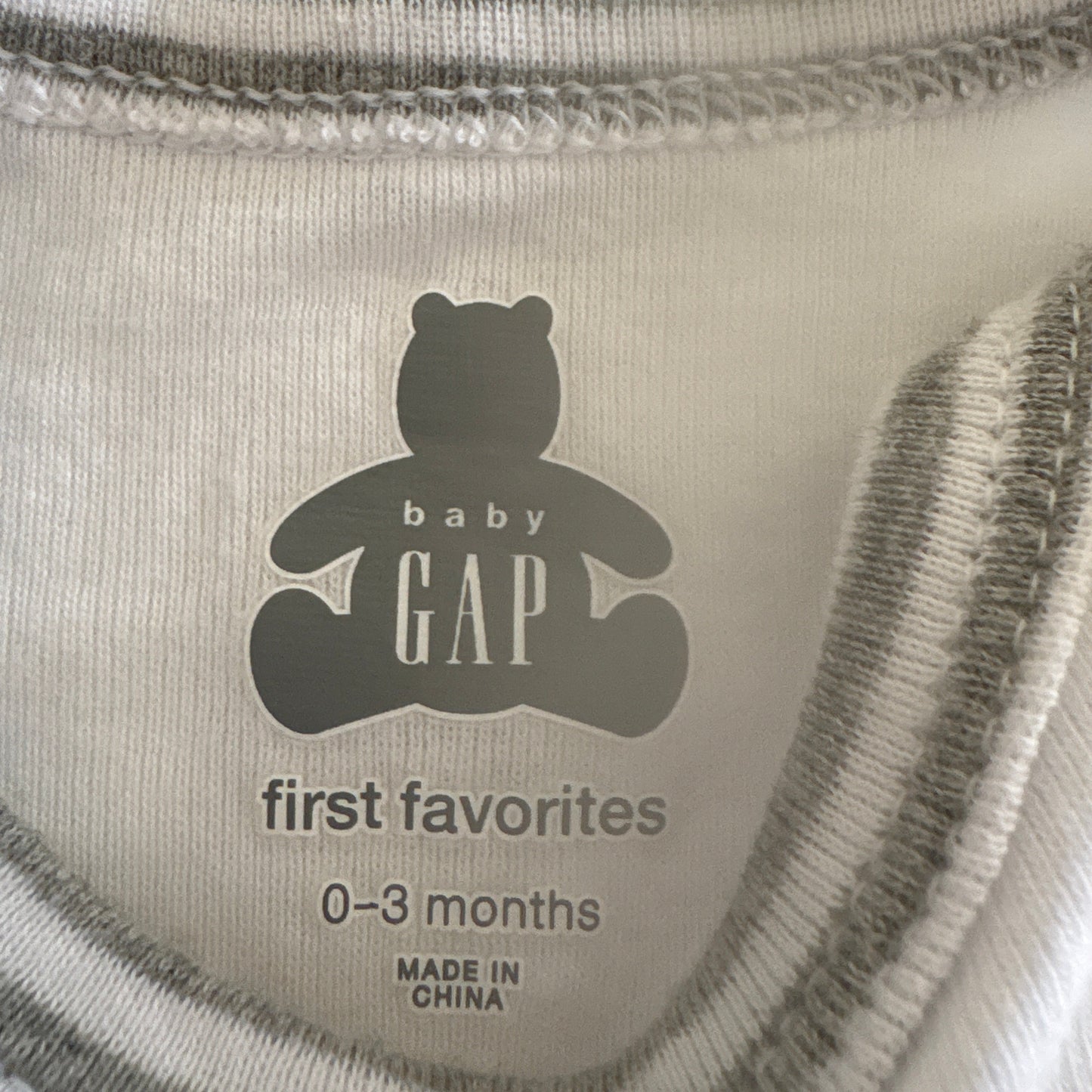 Baby Gap label on a product with 'first favorites' and size information.