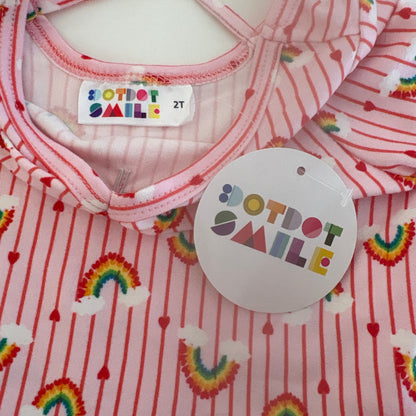 Baby outfit with rainbow patterns and 'Dotdot smile' label on a white background