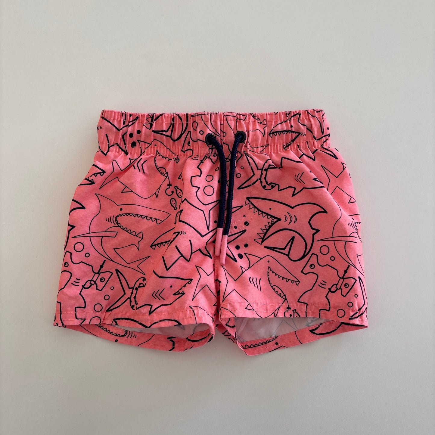 swim trunks with pictures of sharks printed on them