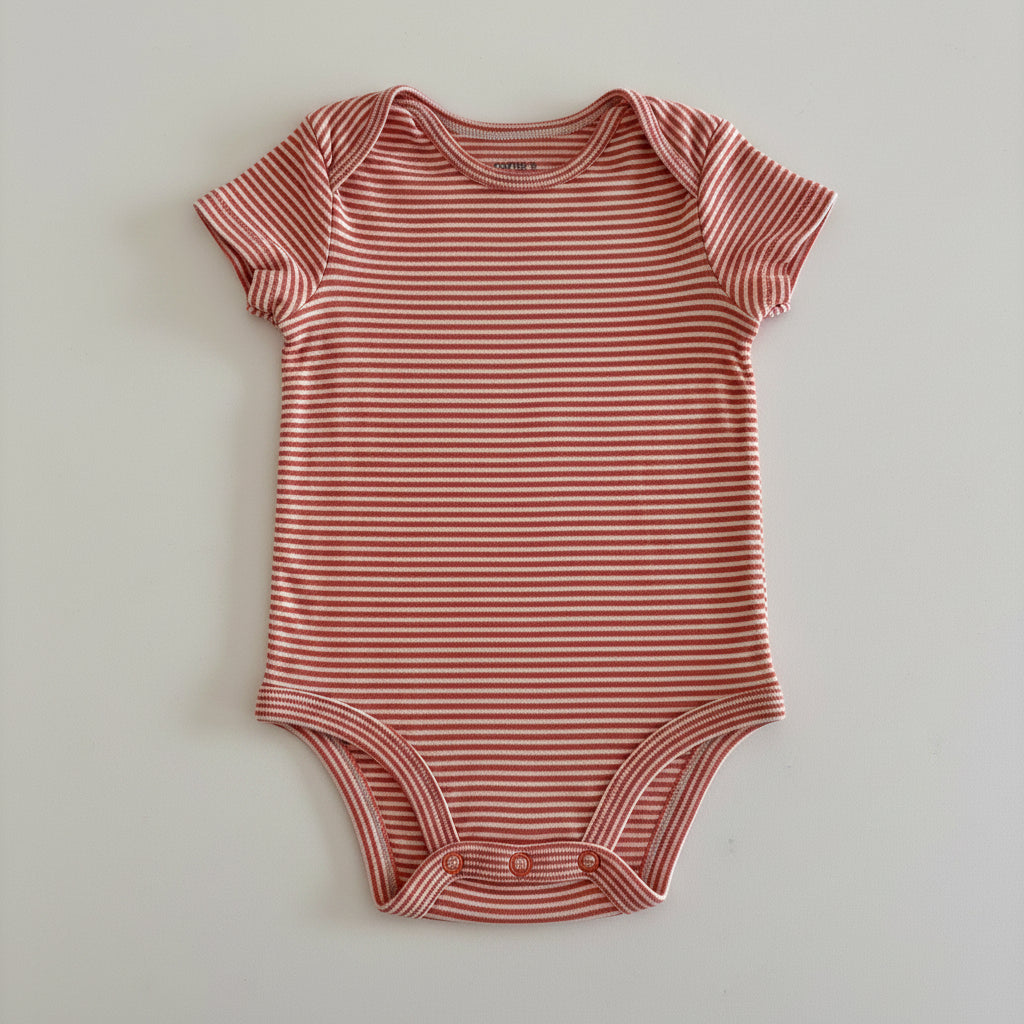 orange and white striped baby onesie on a light gray background
