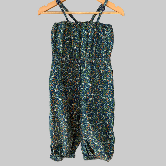 A sleeveless jumpsuit for toddlers with a floral pattern, displayed on a hanger.