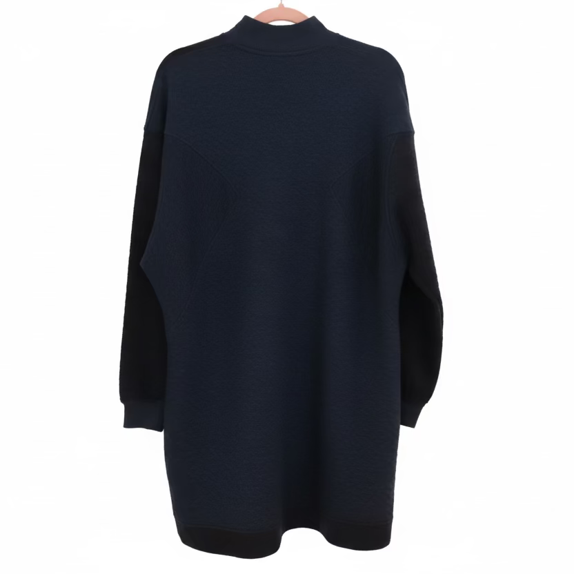 A blue, long-sleeved Hatch maternity dress displayed on a mannequin, showing the back view.