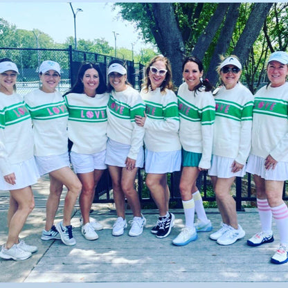 8 Women Wearing a Love Sweater at the Tennis Courts